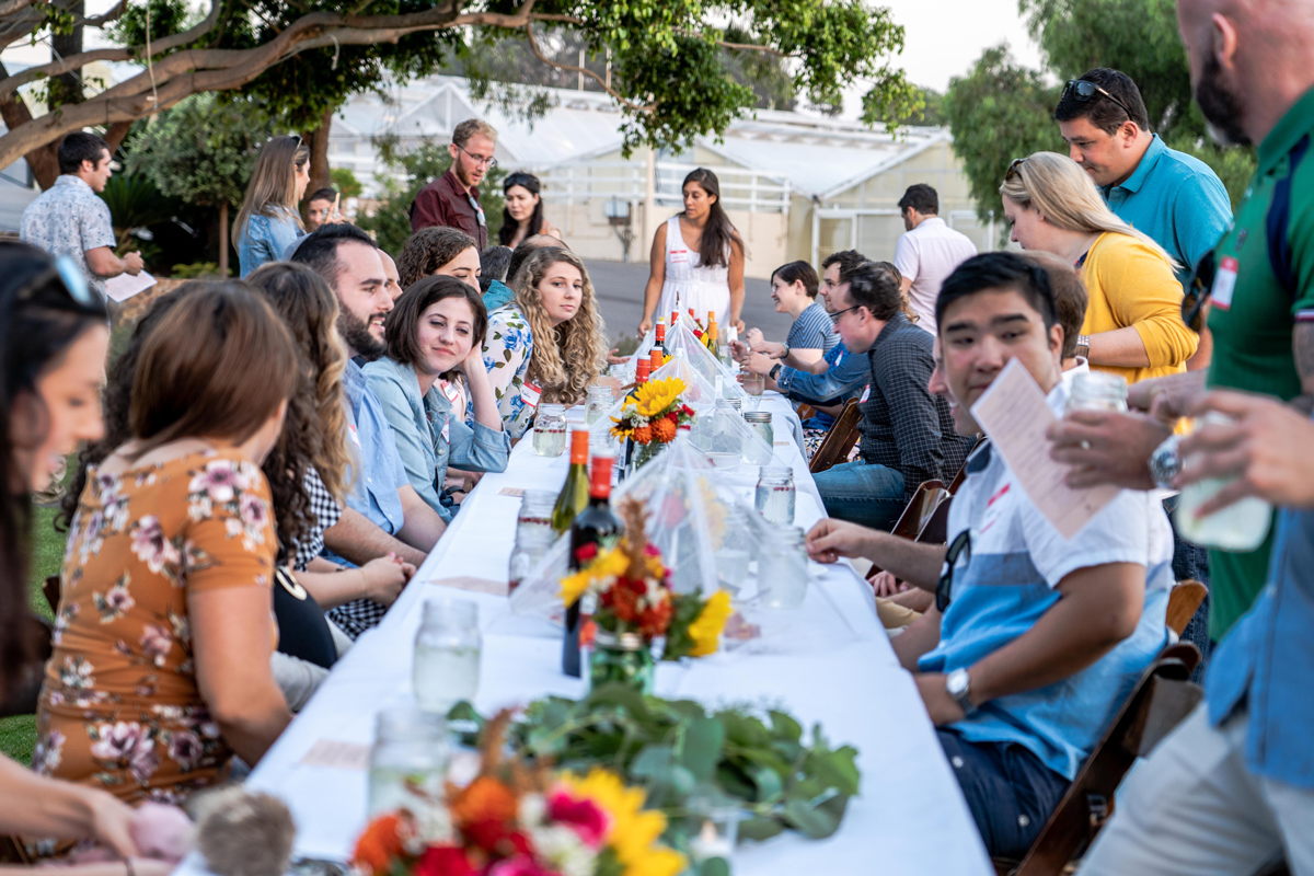 People sit around Shabbat dinner table