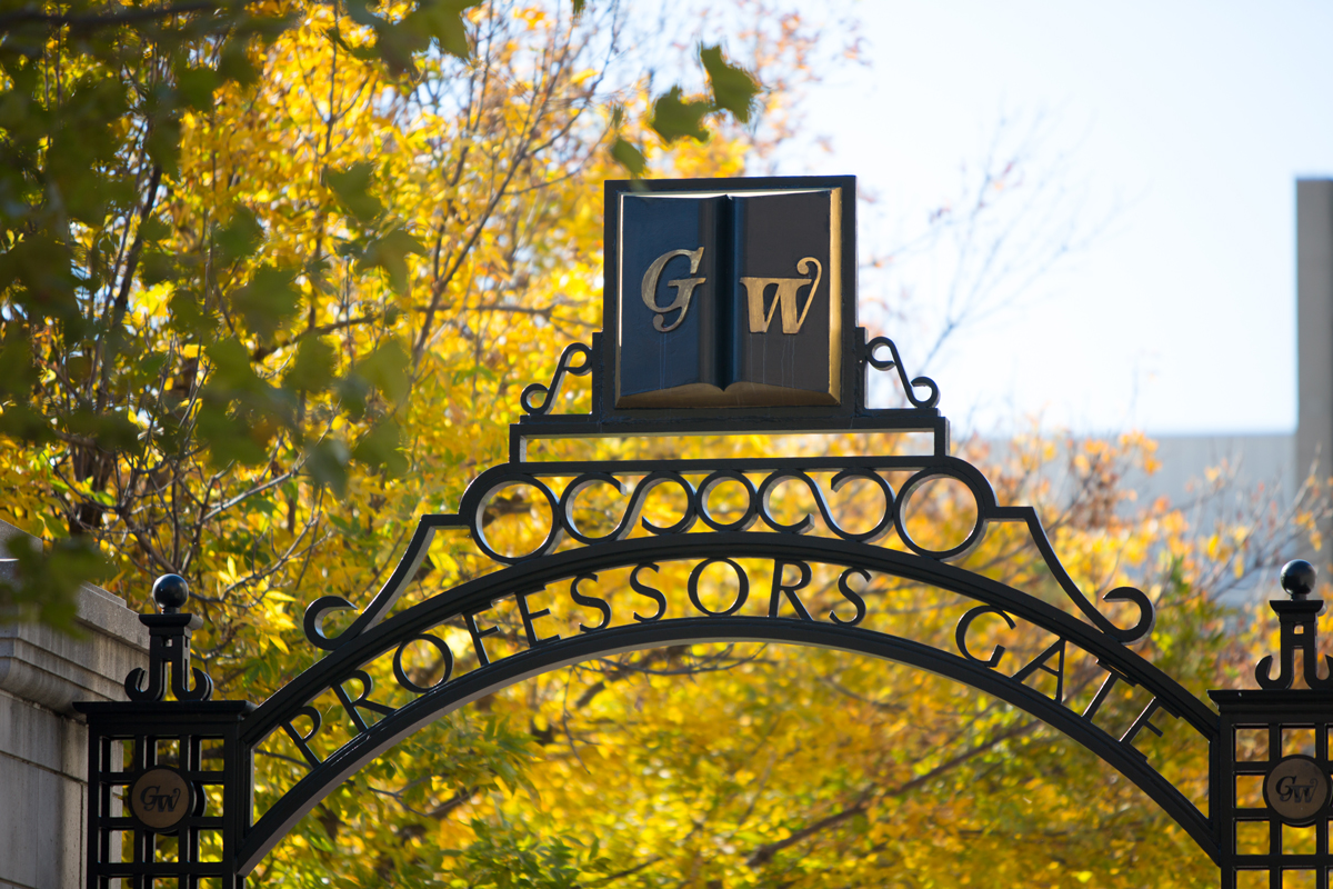 Professor's Gate on GW campus with fall trees in the background