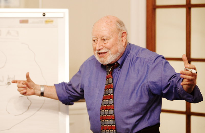 Dr. Lee Shulman raises his hands excitedly as he teaches