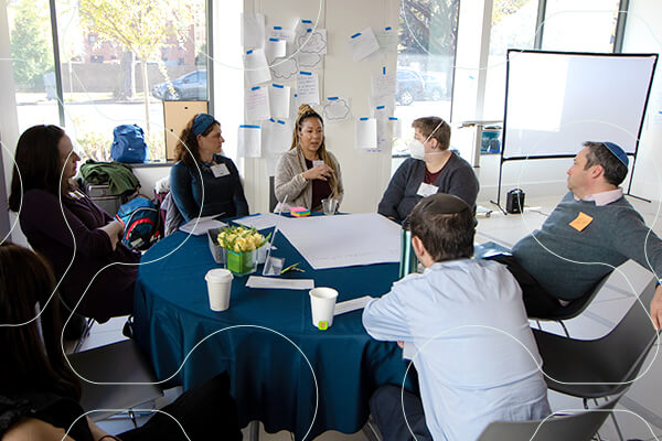 group of professionals talking around small round table