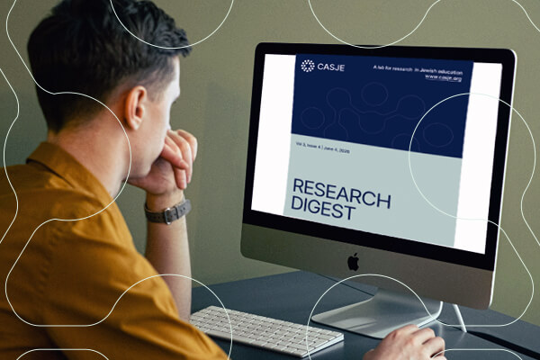 male reads CASJE Research Digest on his computer screen
