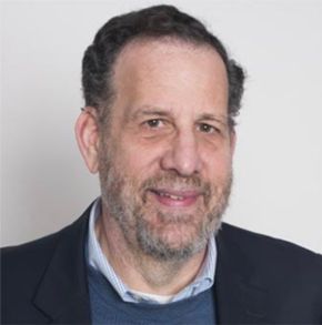 Man with beard in front of grey background