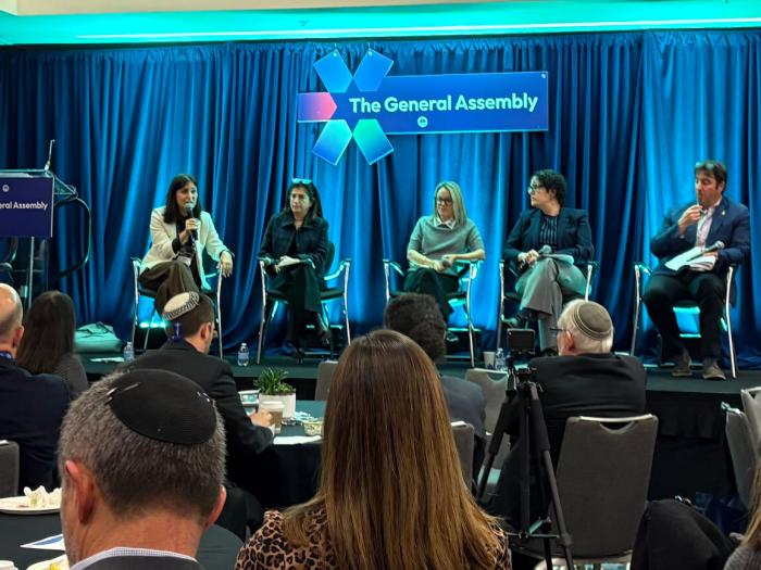 GA Panel - 5 people sit on a stage with a blue background
