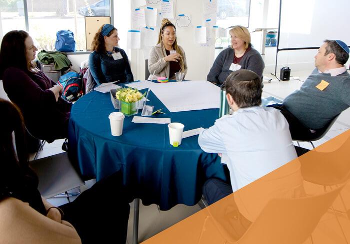 group of professionals talking around small round table