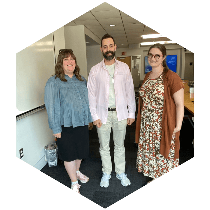 Three CASJE Applied Research Fellows stand together to pose for photo (image is hexagon shaped)