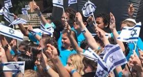 Children hold Israeli flags in the air